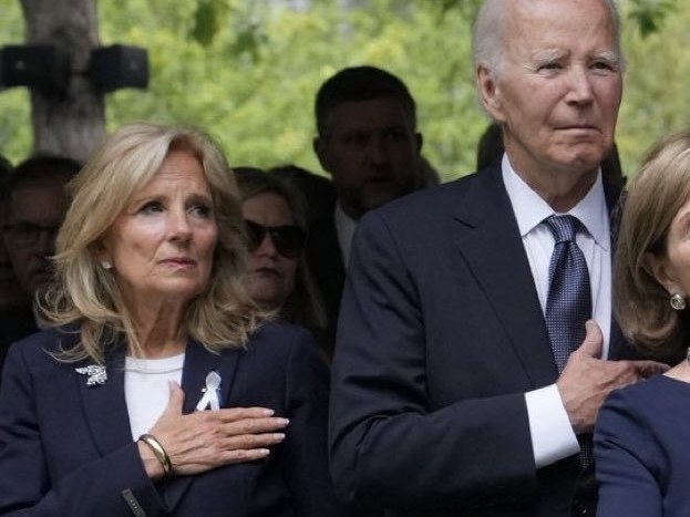 Jill and Joe Biden standing with hands on hearts at a 9/11 ceremony.